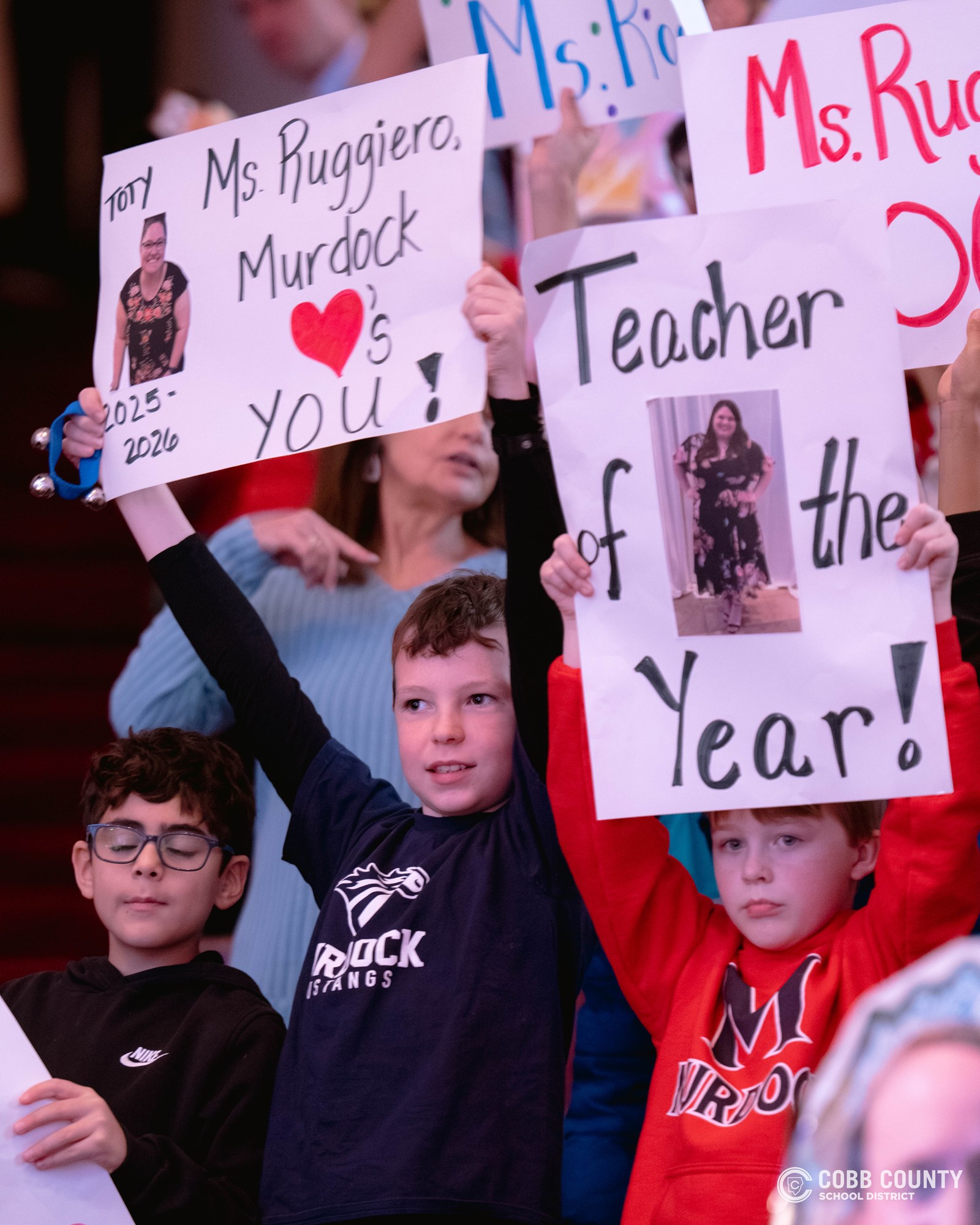 Murdock Elementary students waving signs