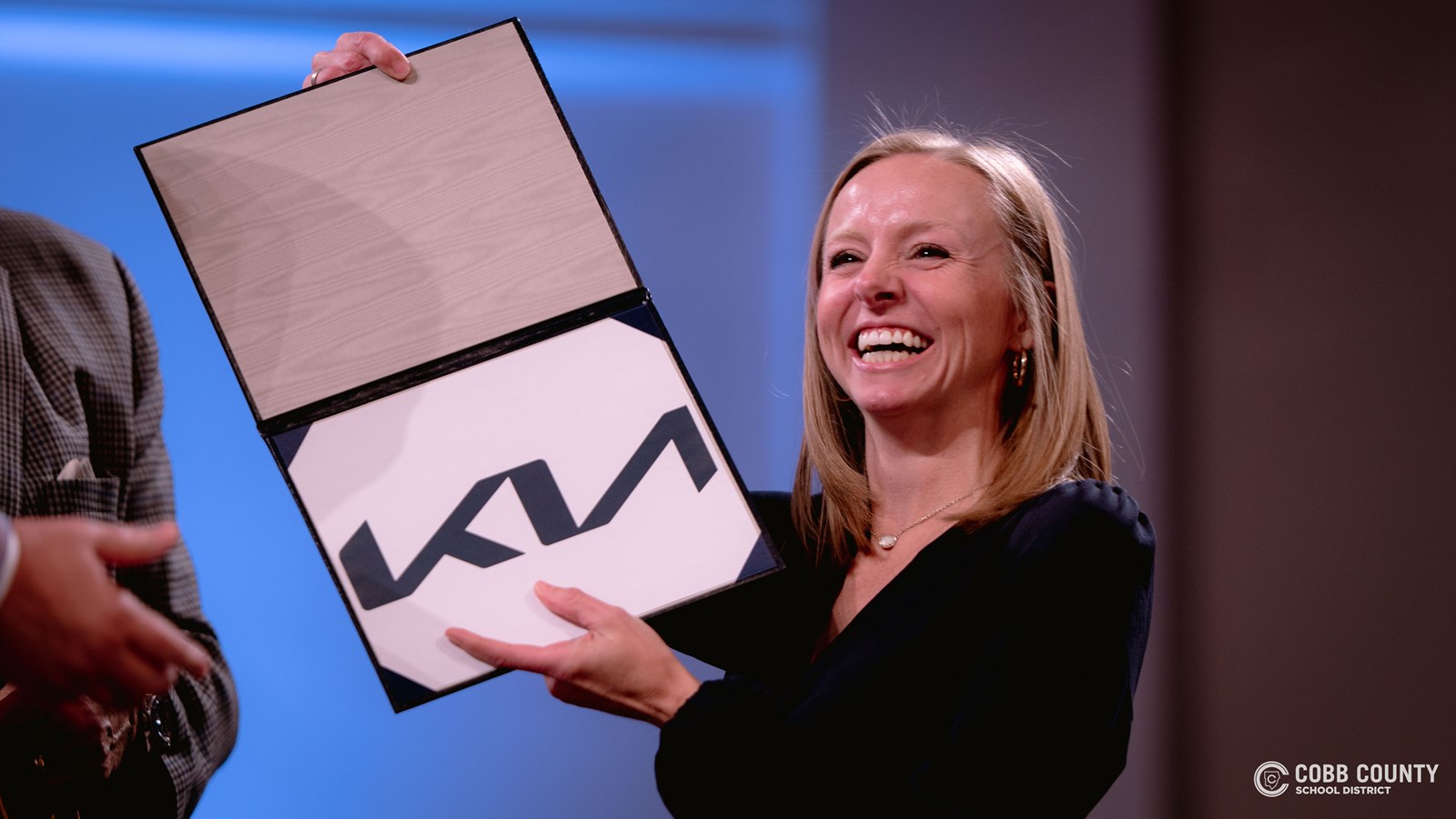 Amanda Dillard holding her winning car brand