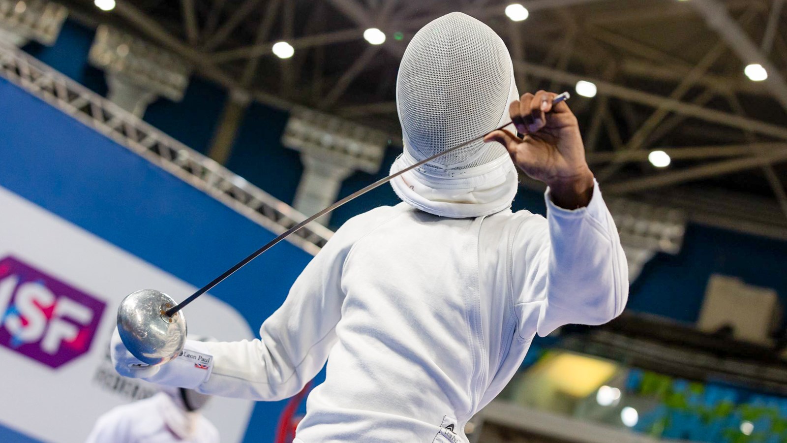 Joshua Riggins tests his épée before a bout