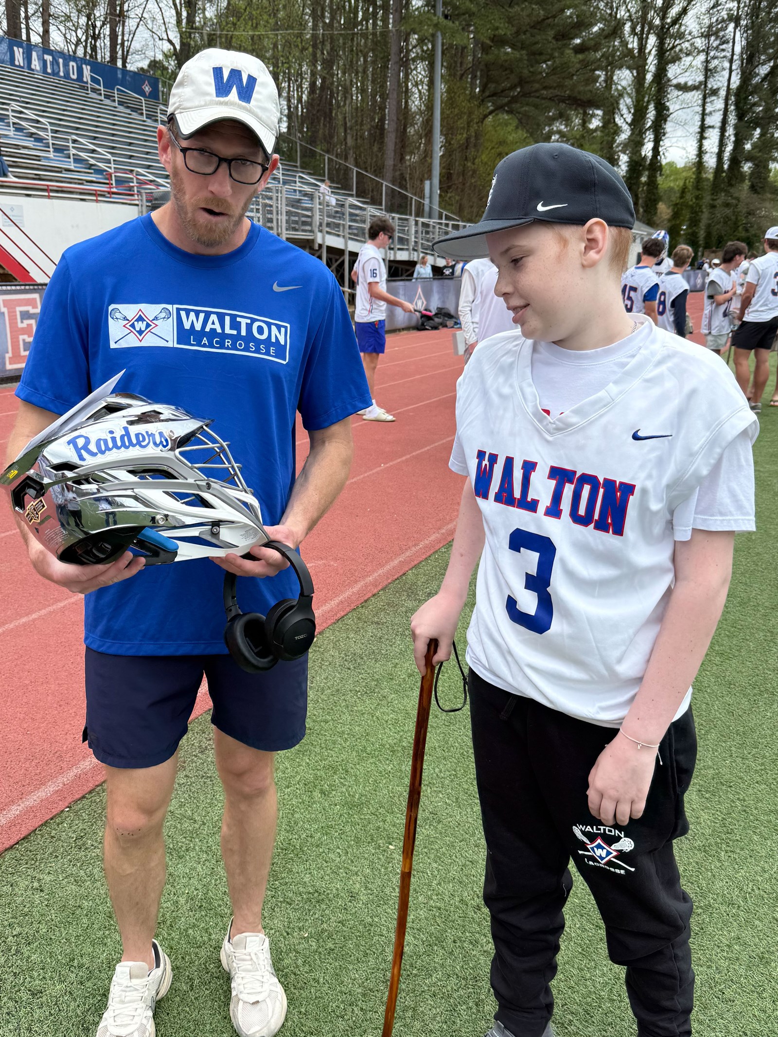 Coach Spotz presents Jackson with a limited edition Walton chrome helmet