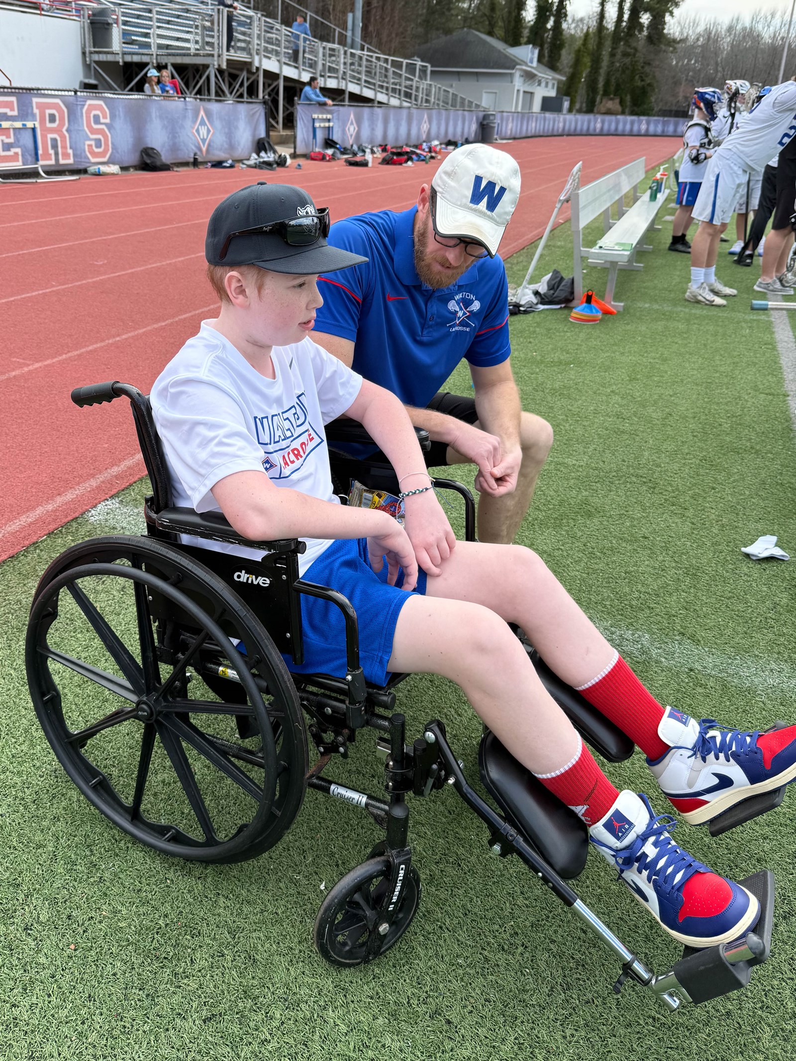 Coach Spotz checks in with Jackson on the sidelines