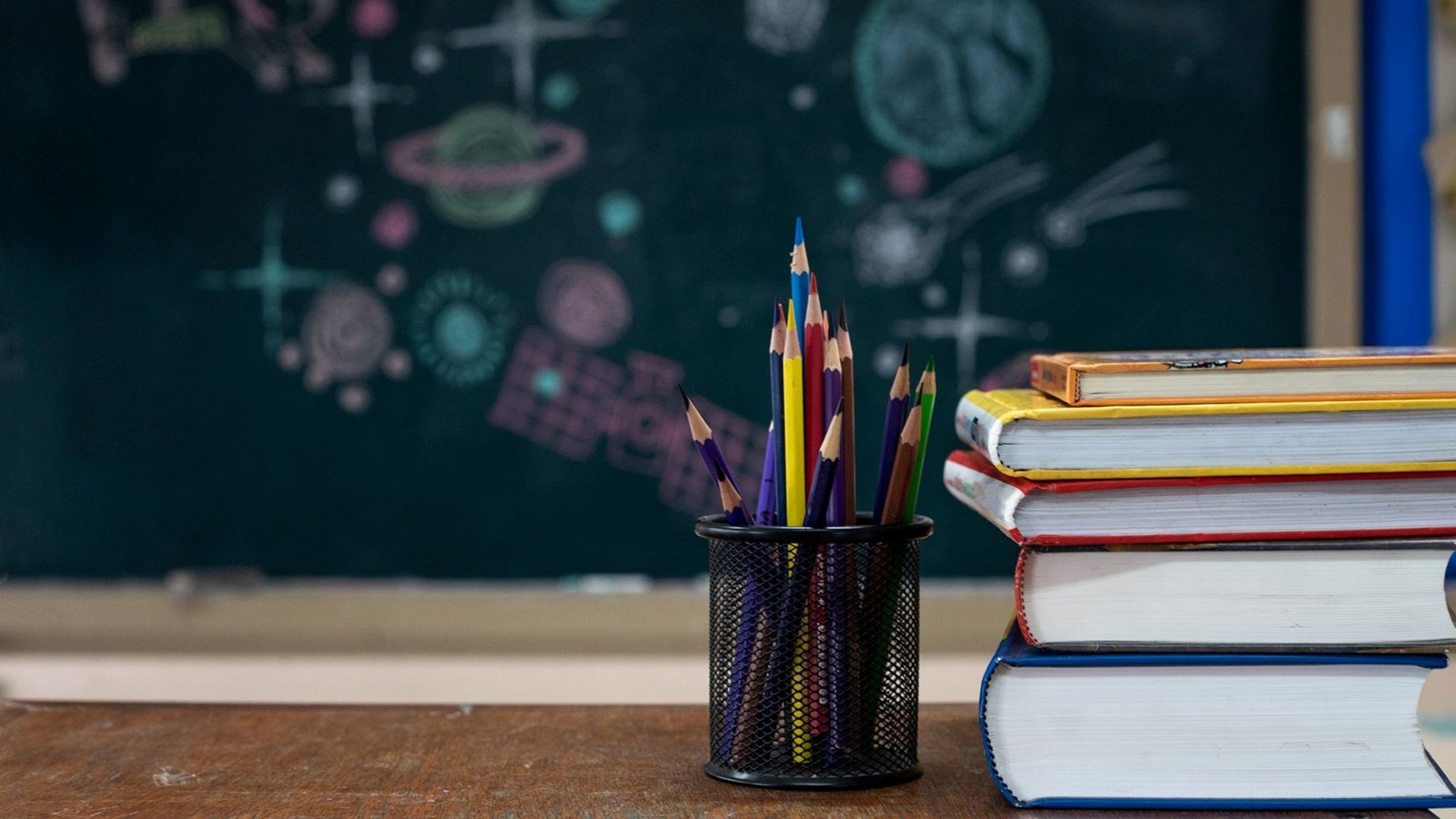 Pencils, books, and chalk board