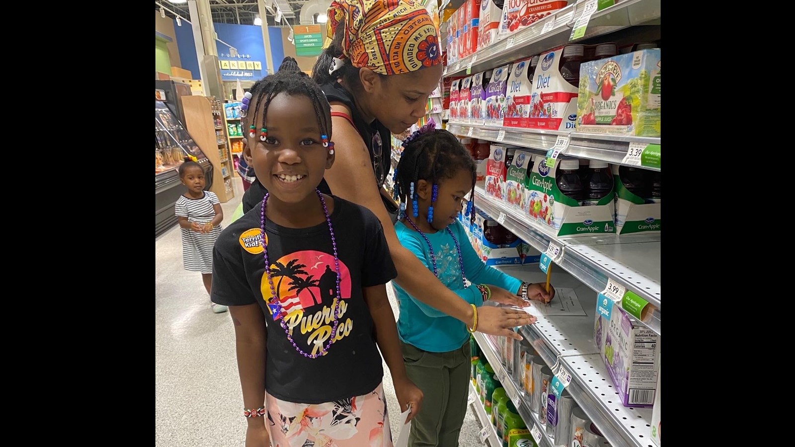 Students and parent working math problem at Publix