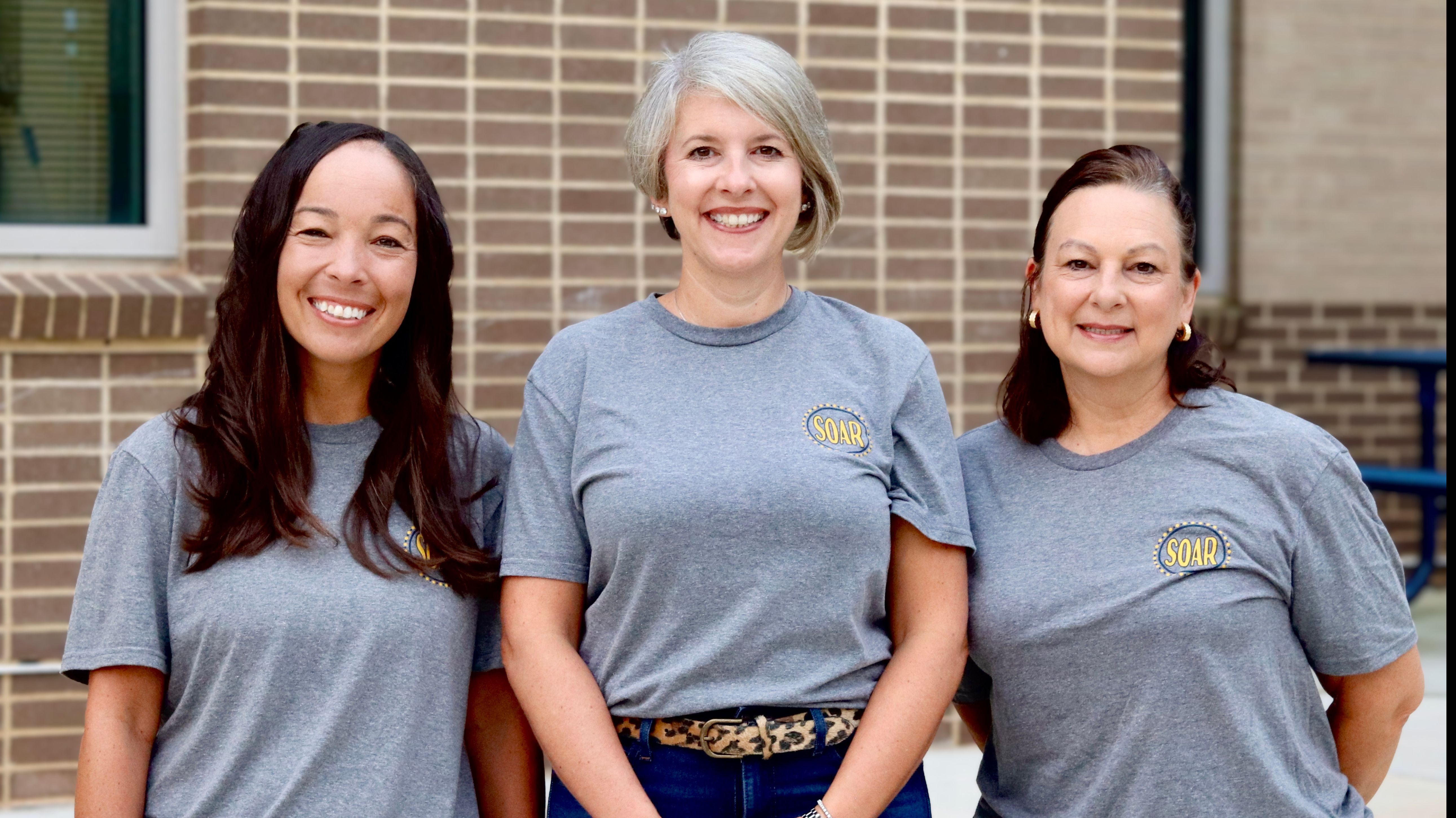 three ladies smiling