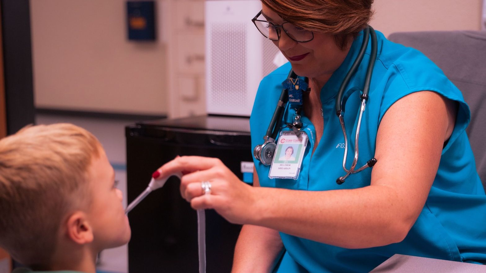 KSE Nurse Heather taking a student's temperature
