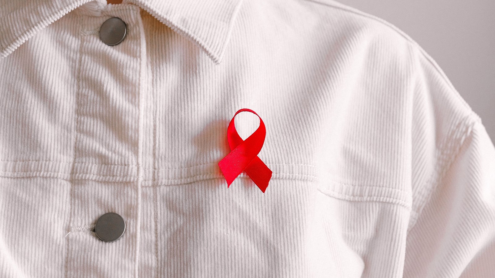 man wearing red ribbon