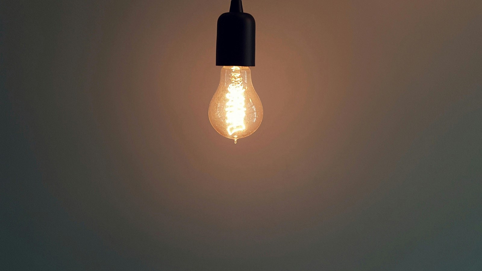 Edison light bulb hanging from the ceiling in an empty room