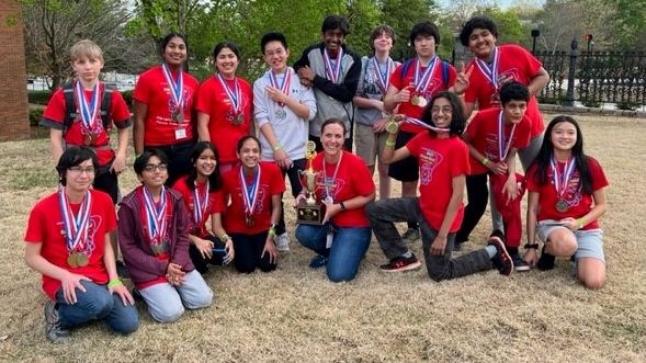 Science Olympiad team members and coach, holding trophy from 2nd place finish!