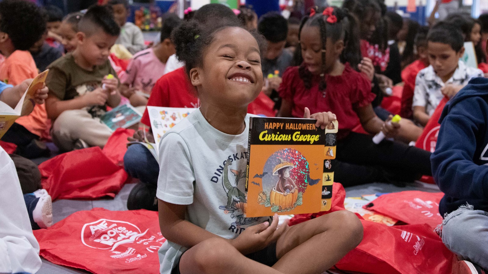 Riverside Elementary student shows off one of her new books donated by the community.