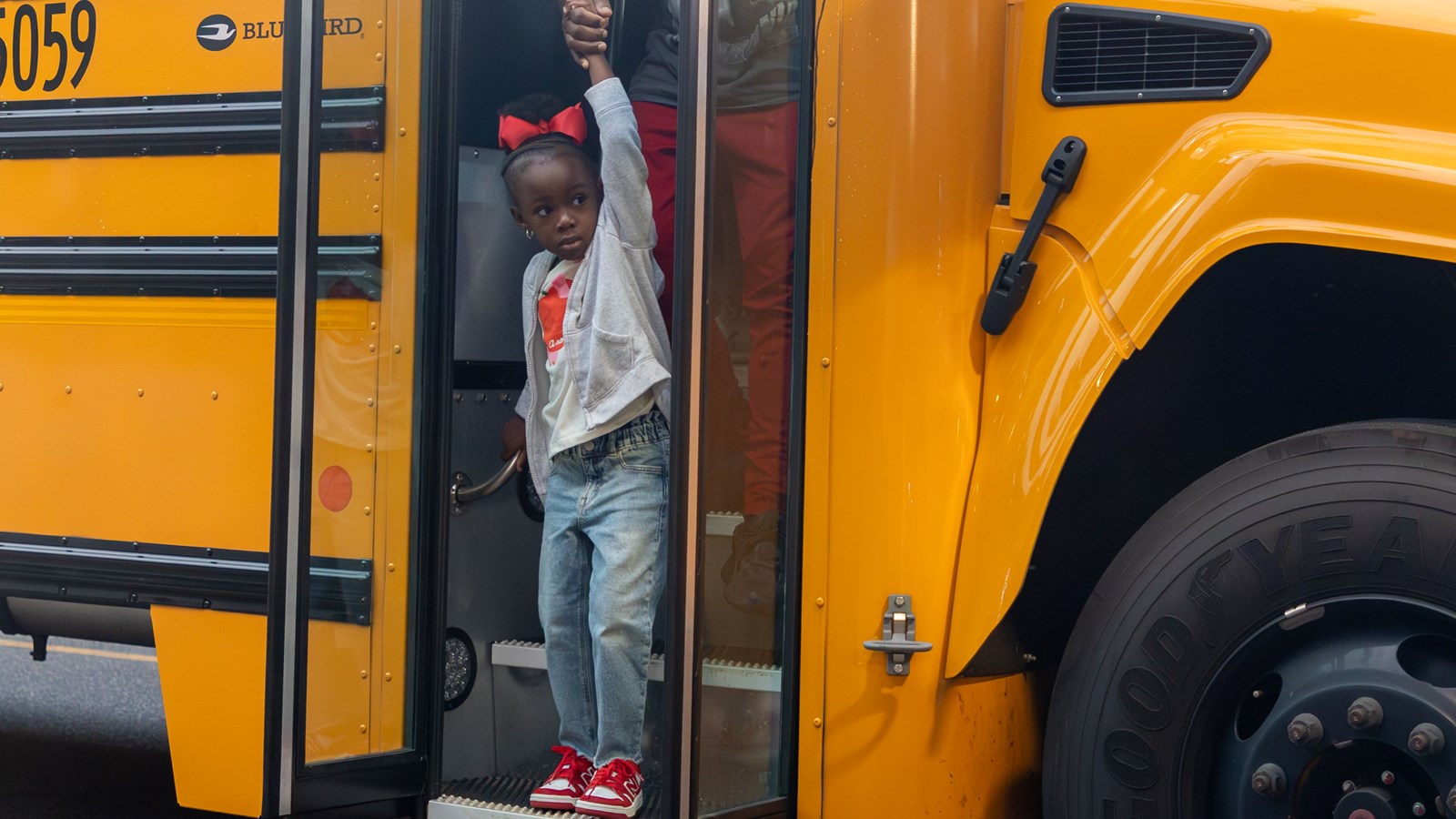 A student at Cheatham Hill Elementary School steps off the bus after the annual ride along.