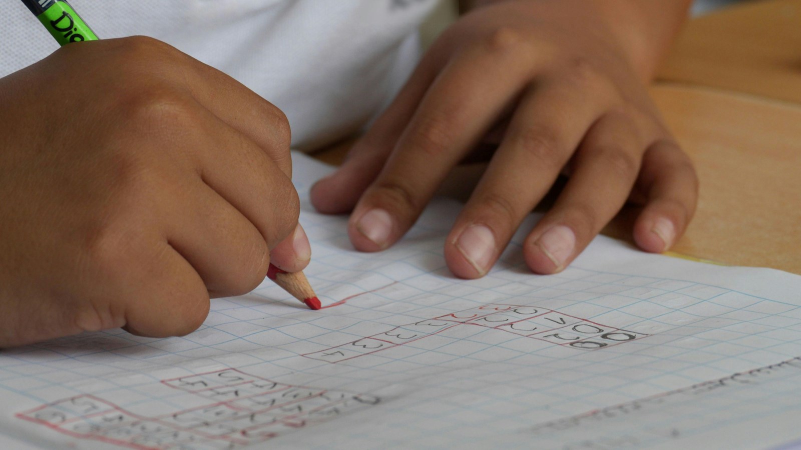 Child writing on white paper