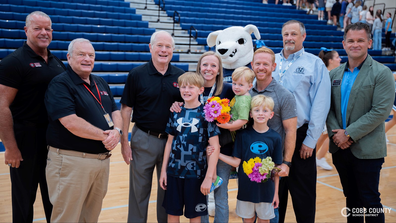 Special Education teacher Amanda Dillard celebrates with her husband and children, Cobb Schools Board Members, Pope Principal Matthew Bradford, and Superintendent Chris Ragsdale after being honored as the Cobb Schools 2025 Teacher of the Year.