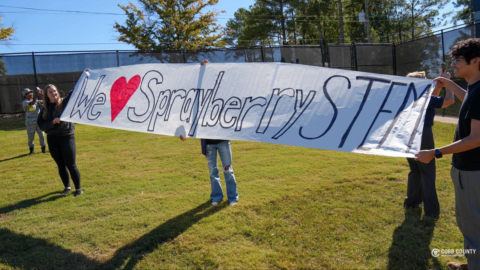 Students held up a banner for their teachers to see as they were in the planes.