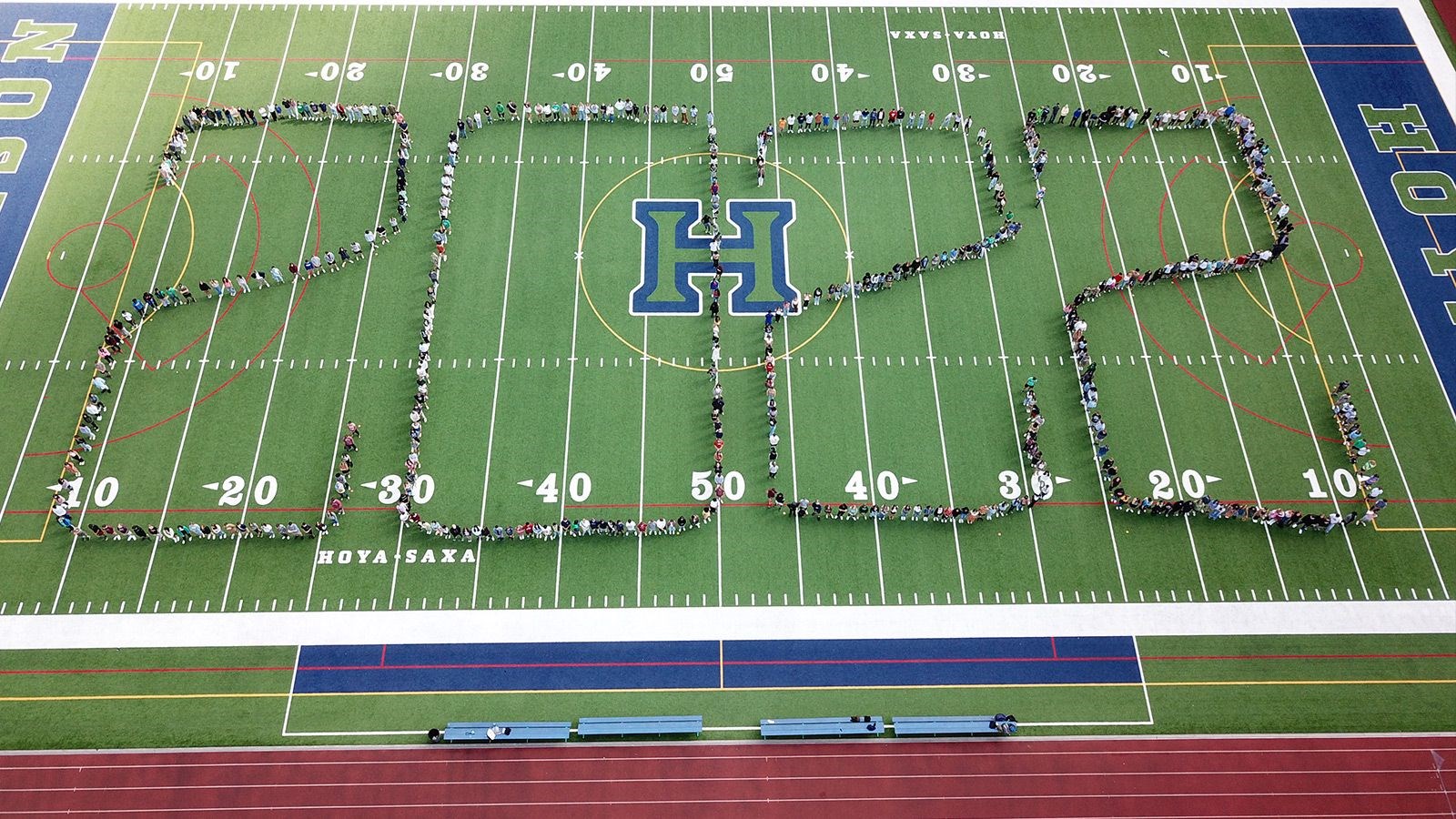 Seniors on the field writing out 2022